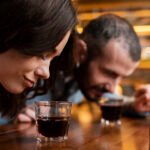 close up couple smelling cups coffee